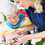 Nurse helping mature adult